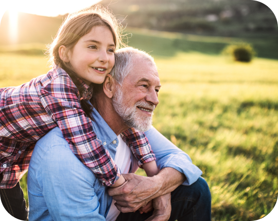 A grandfather and granddaughter spending time together outdoors